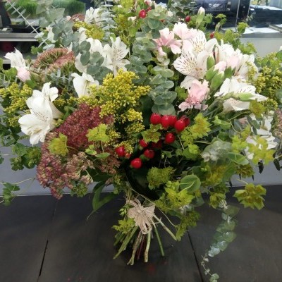 Arranjo floral colorido em vaso com flores e folhas verdes