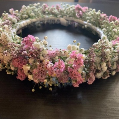 Coroa de flores naturais secas em tons de rosa, branco e roxo