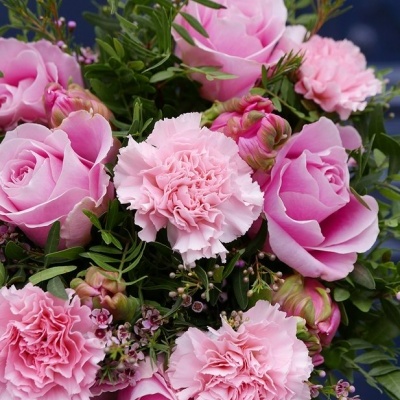 Buquê de rosas e cravos cor-de-rosa com folhagem verde