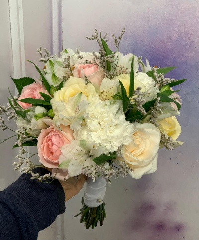 Ramo de flores com rosas brancas e rosa, flores e folhas verdes, fundo lilás