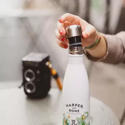 Garrafa térmica branca com design colorido de gato e plantas