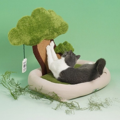 Cama para gato com árvore em tecido verde e castanho e gato cinzento e branco a usar