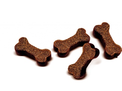 Biscoitos para cães em forma de osso castanhos sobre fundo branco