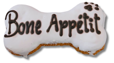 Biscoito para cães em forma de osso com glacê branco e texto 'Bone Appétit' em glacê preto