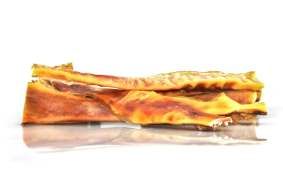 Pedaços de pele de boi cru castanha clara para cães sobre superfície branca