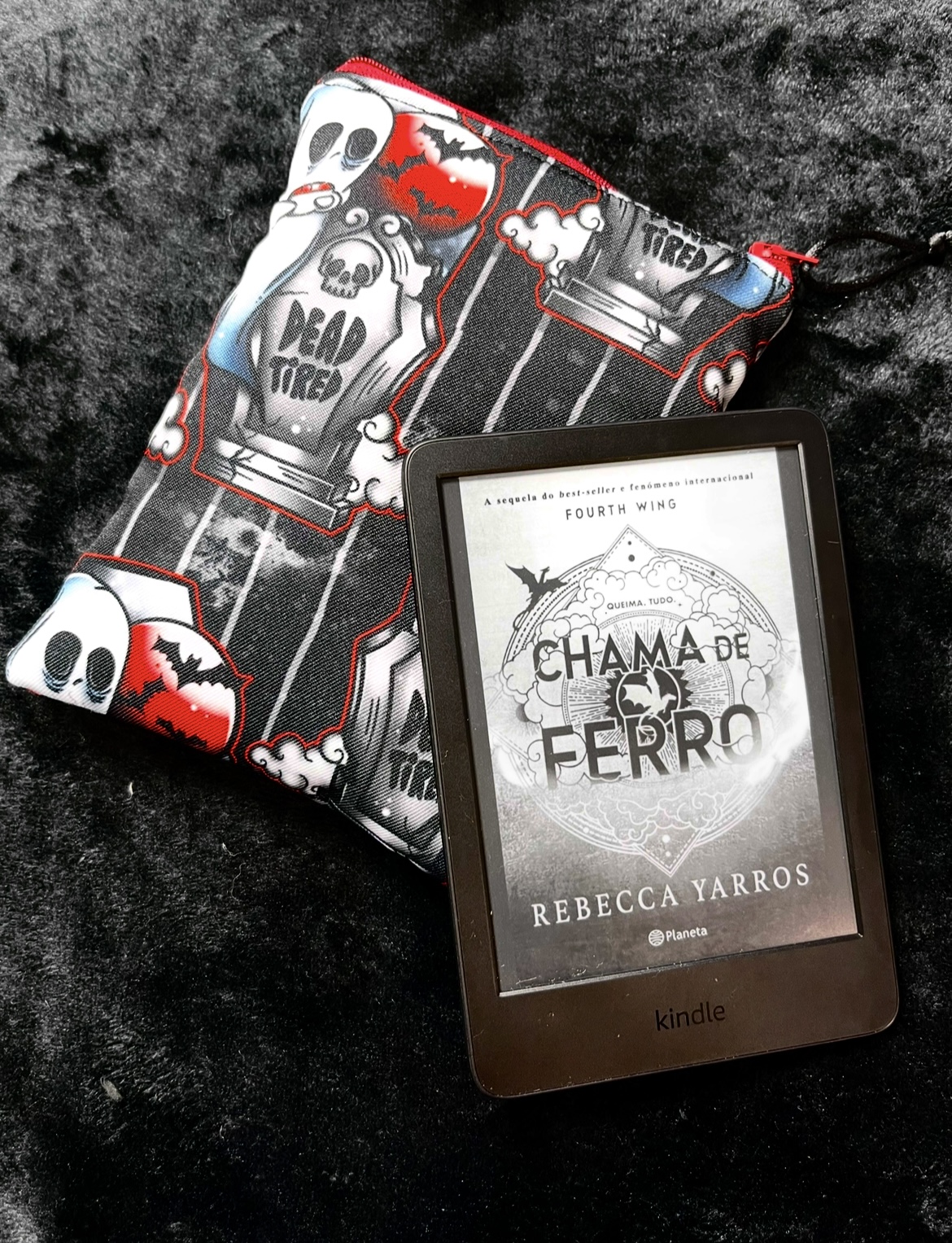 Dead Tired E-Reader Kindle e-reader with book cover next to Halloween-themed fabric pouch