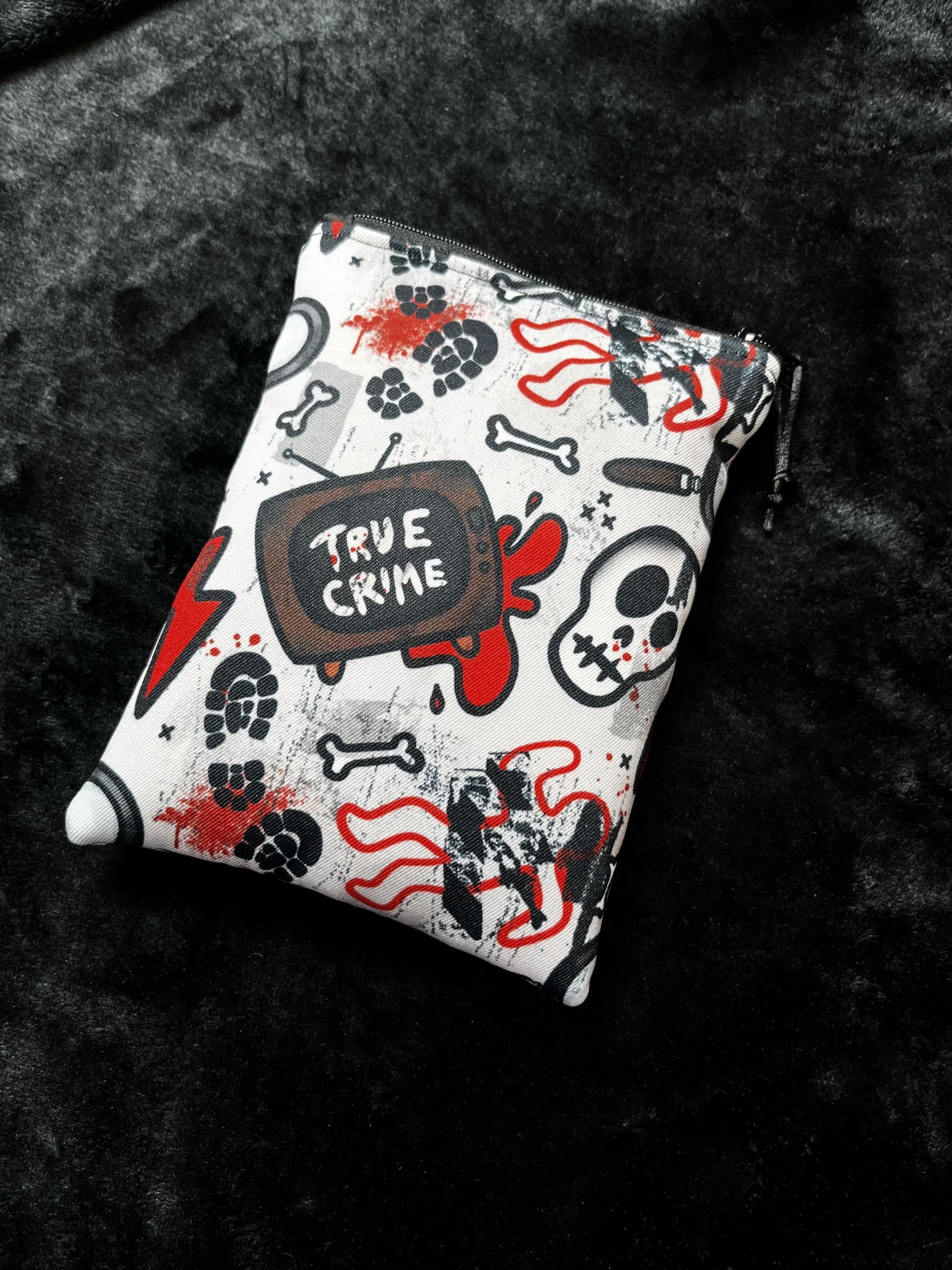 True Crime E-Reader White TRUE CRIME graphic zippered pouch on black fabric