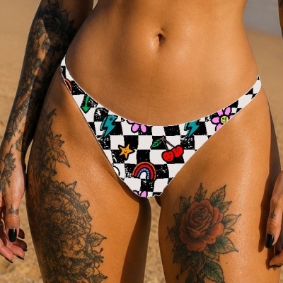 Checkered bikini bottom with colorful playful patterns on a person at the beach