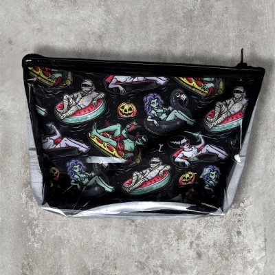 Black zippered pouch with colorful cartoon monsters on pool inflatables pattern