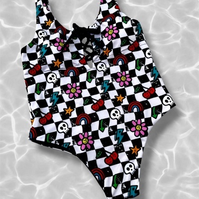 Colorful one-piece swimsuit with cartoon icons on black and white checkered pattern