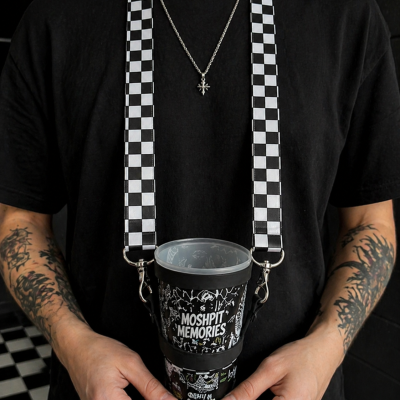 Black cup with MOSHPIT MEMORIES text and designs on a checkered strap worn by a person in a black t-shirt