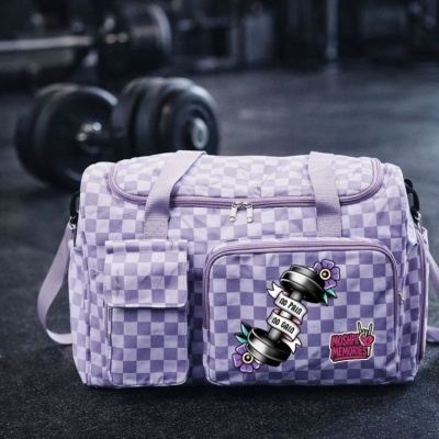 Lavender and white checkered gym duffel bag with patches on gym floor