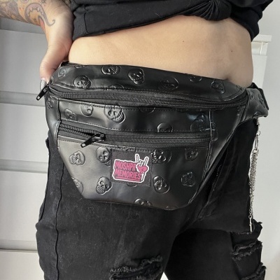 Black skull-embossed fanny pack with MOSHPIT MEMORIES patch worn on waist
