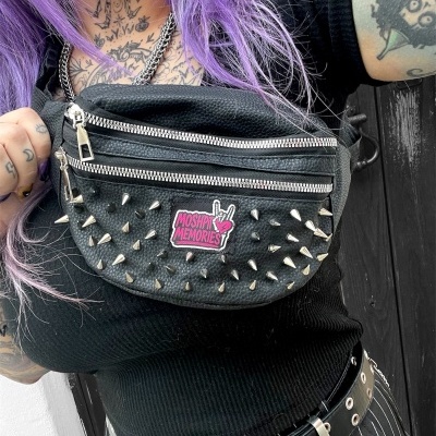 Black leather spiked fanny pack with MOSHPIT MEMORIES patch and silver zippers worn on person with purple hair and tattoos