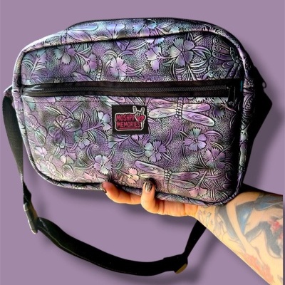Purple shoulder bag with floral and dragonfly pattern and MOSHPIT MEMORIES label.