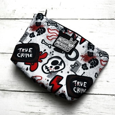 Fabric pouch with skull, bones, hearts, paw prints pattern and text TRUE CRIME and MOSH PIT MEMORIES label