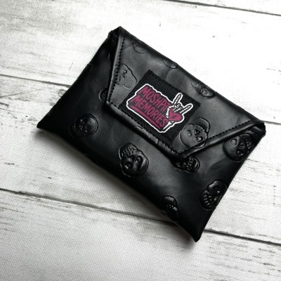 Black leather wallet with skull embossing and MOSH PIT MEMORIES patch on wooden surface