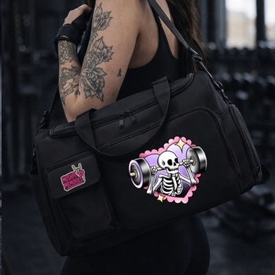 Black gym duffel bag with skeleton weightlifting graphic and MOSHPIT MEMORIES patch