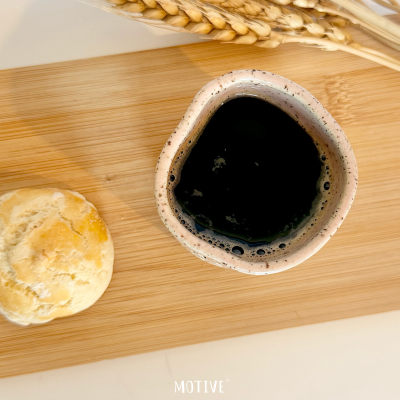 Chávena com café, pão, espigas de centeio e tabuleiro de madeira