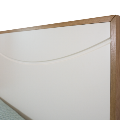 Cabeceira de cama de madeira clara com painel branco e padrão em relevo