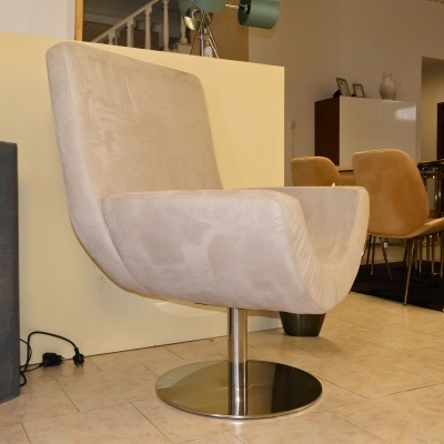 Cadeira giratória cinza com base metálica num ambiente interior