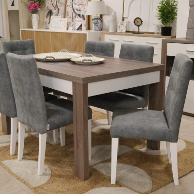 Mesa de jantar retangular em madeira com cadeiras cinza sobre tapete em padrão circular