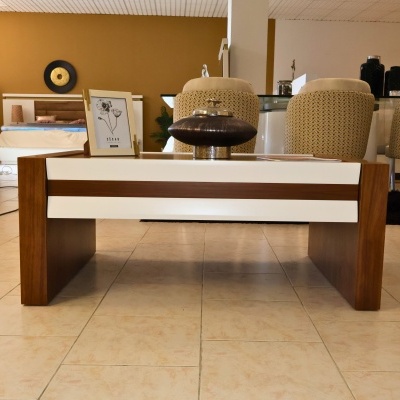 Mesa de centro madeira castanha e branco com jarro cerâmico castanho e moldura de foto amarela