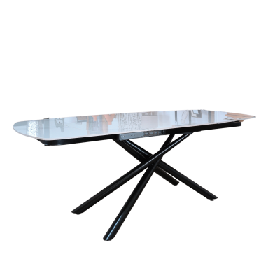 Mesa de jantar com tampo branco de vidro e estrutura metálica preta em forma de X