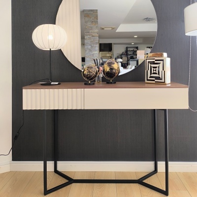 Consola creme e castanha com pernas pretas, espelho redondo e objetos decorativos