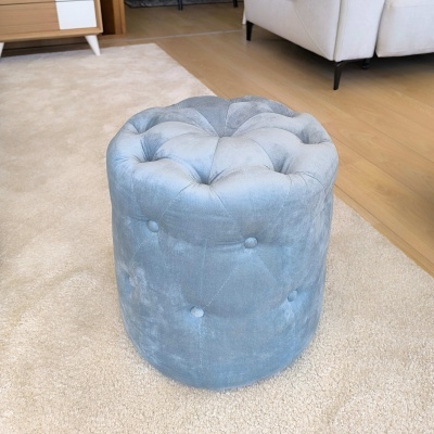 Pufe redondo azul claro de tecido aveludado com botãozinhos