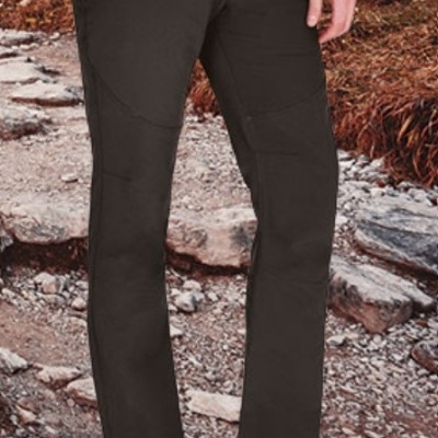 Calças pretas resistentes em trilho rochoso