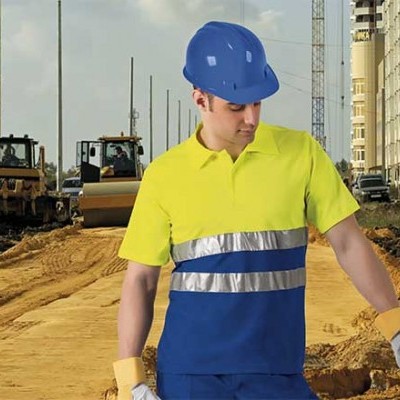 Homem em roupa de segurança azul e amarela numa obra