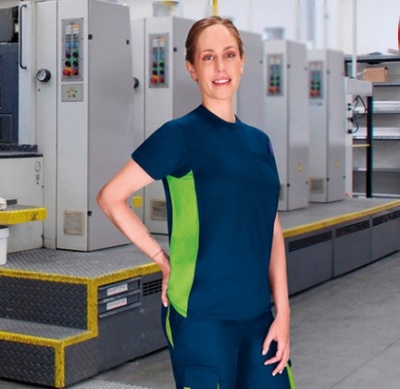 Roupa de trabalho azul escuro com painéis verdes em ambiente de fábrica