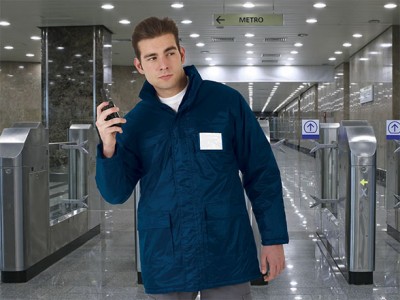 Homem com parka azul escura numa estação de metro
