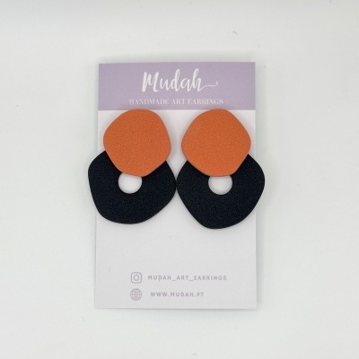 Brincos artísticos laranja e preto em cartão de apresentação