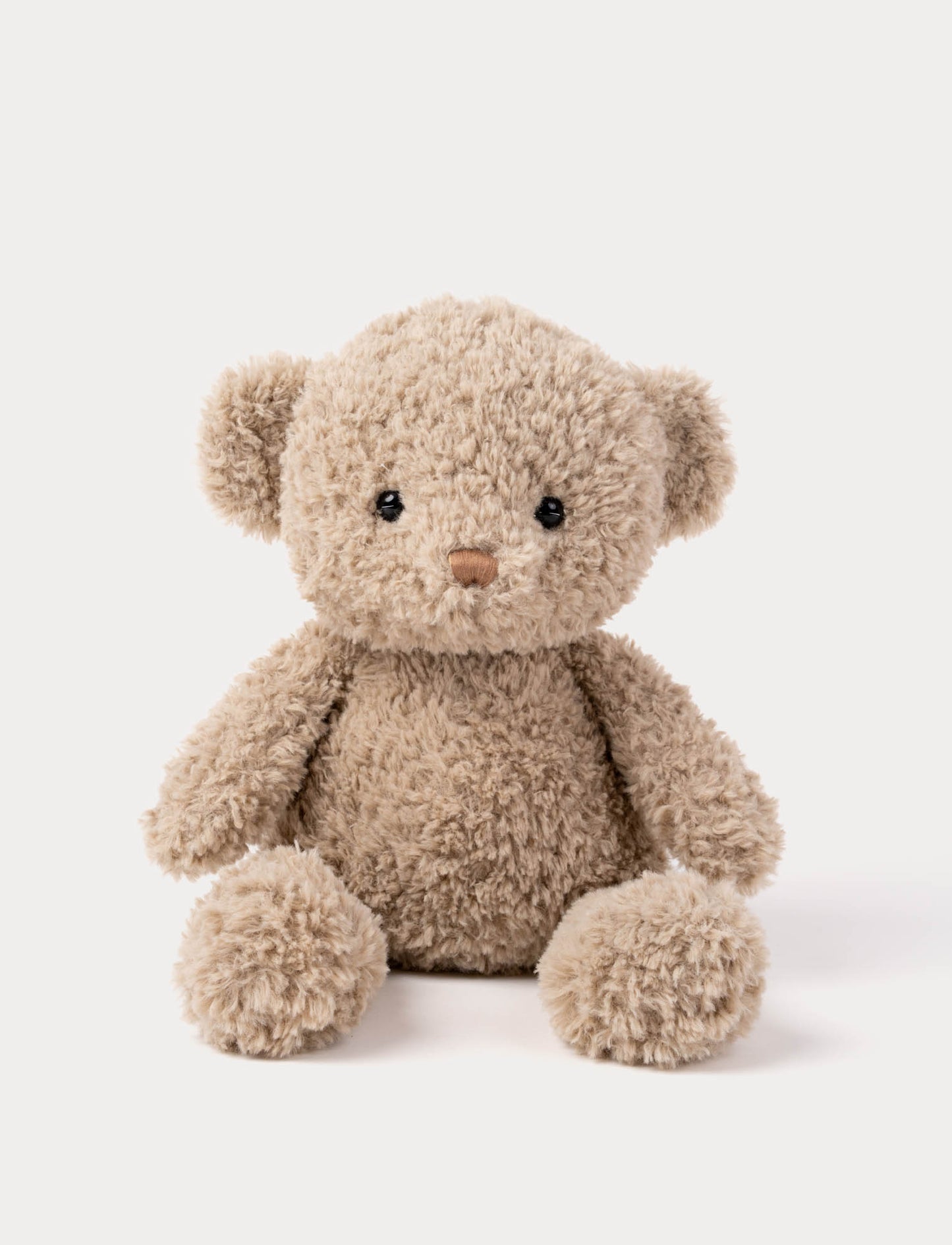 Ursinho de peluche castanho claro felpudo com olhos negros e nariz castanho