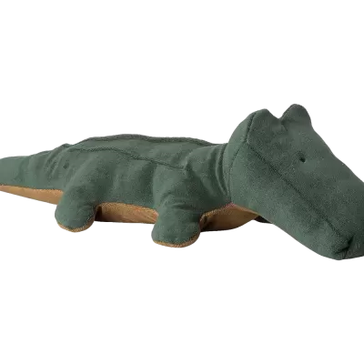 Pelúcia verde de crocodilo em fundo neutro claro