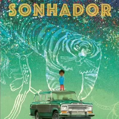 Capa do livro SONHADOR com criança em cima de carro verde e tigre desenhado ao fundo