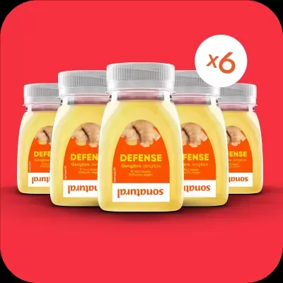 Seis frascos com líquido amarelo e rótulo laranja com texto DEFENSE e gengibre