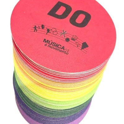 Pilhas de discos coloridos com texto 'DO' e 'MÚSICA e movimento'