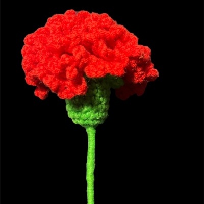 Flor vermelha de tricô ou crochê com caule verde sobre fundo preto