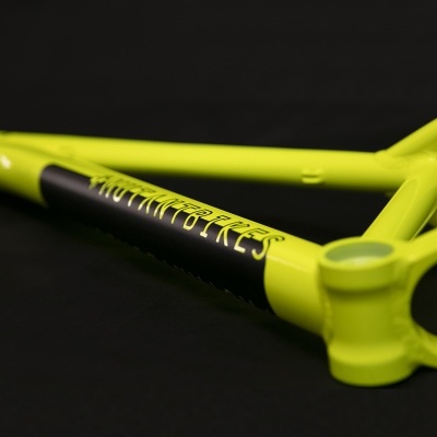 Estrutura de bicicleta amarela fluorescente com texto 'MOTHER CORE'