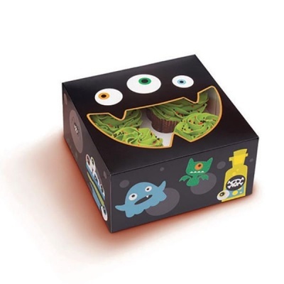 Caixa preta com monstros coloridos e janela em forma de boca mostrando cupcakes verdes