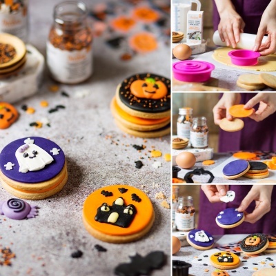 Bolachas decoradas de Halloween com fantasmas, abóboras e gato preto, cores laranja, preto, roxo e branco.