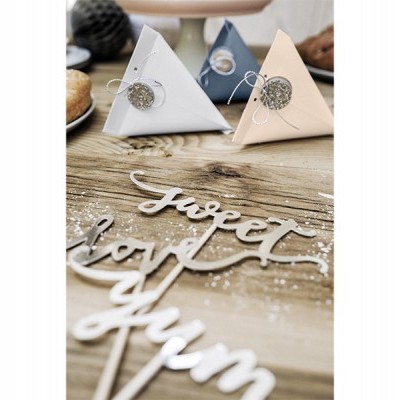 Duas caixas triangulares em papel branco e bege com etiquetas prateadas e frase em madeira 'sweet' sobre mesa