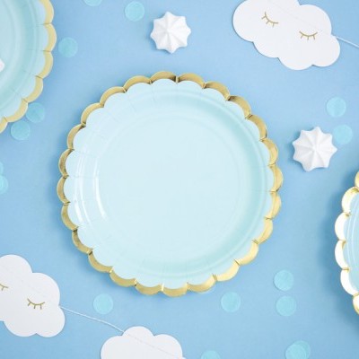 Pratos descartáveis azuis com borda dourada, suspiros brancos, confetes azuis e nuvens de papel branco decorativas