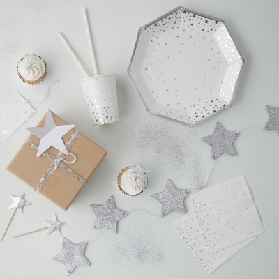 Conjunto de festa com papel, copos, guardanapos, cupcakes, caixa presente e decoração de estrelas prateadas