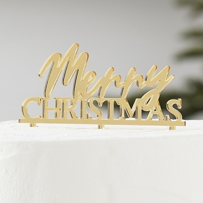 Decoração dourada com a frase 'Merry CHRISTMAS' em acrílico