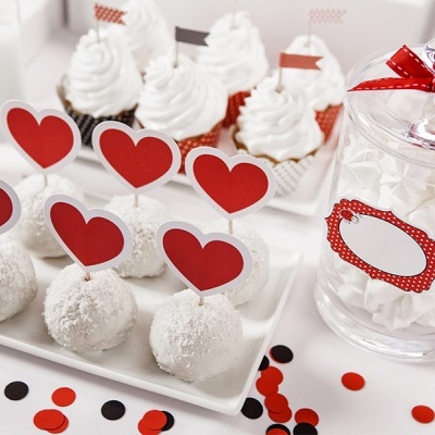 Doces com palitos e corações, frasco com confeitos brancos e confetes coloridos