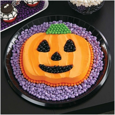 Bolo de Halloween em forma de abóbora decorado com balas coloridas